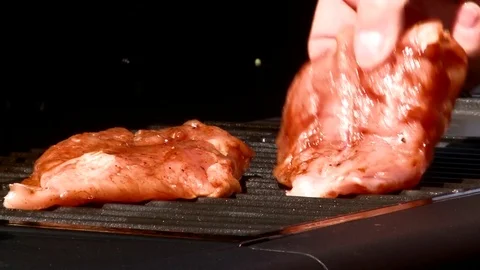 Chicken breast put on the grill Stock Footage 84992030