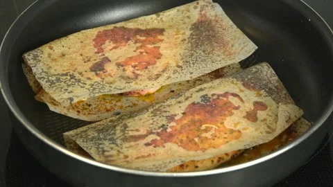 Chicken breast in special sheets for frying without oil is cooked in a pan. F Stock Footage 131113454