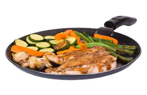 Chicken breasts with vegetable on a griddle 스톡 사진