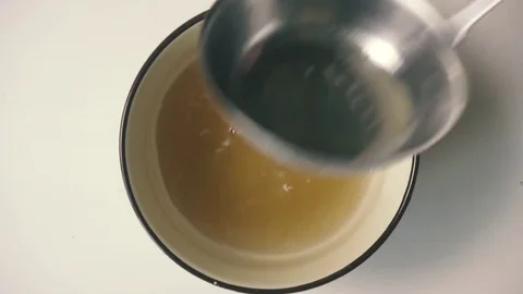 Chicken broth with egg and parsley. Top view Stock Footage 73740232