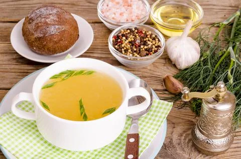 Chicken broth soup in white plate. Photo Stock Photos