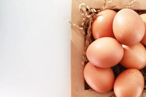 Chicken brown eggs on a white table 스톡 사진
