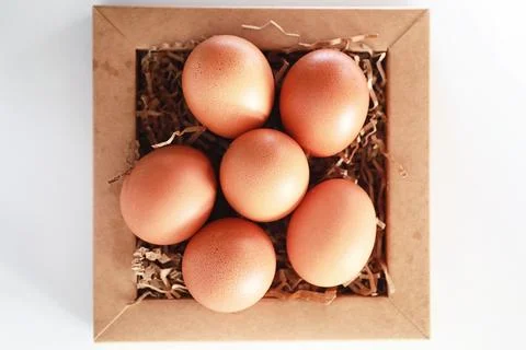 Chicken brown eggs on a white table 스톡 사진