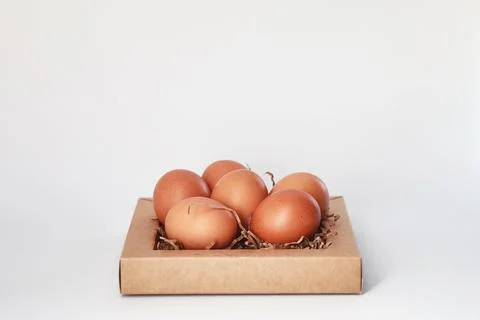 Chicken brown eggs on a white table 스톡 사진