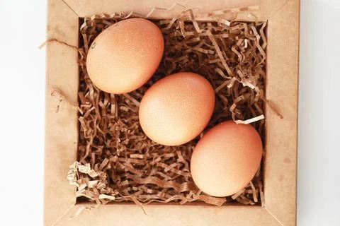 Chicken brown eggs on a white table 스톡 사진
