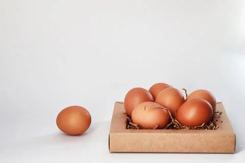 Chicken brown eggs on a white table 스톡 사진