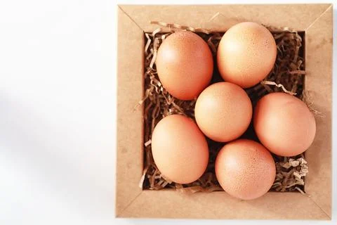 Chicken brown eggs on a white table Stockfoto's