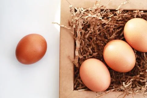 Chicken brown eggs on a white table 스톡 사진