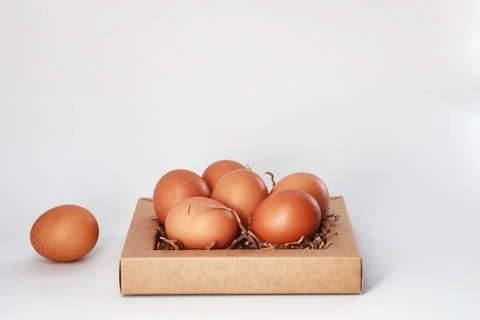 Chicken brown eggs on a white table 库存照片