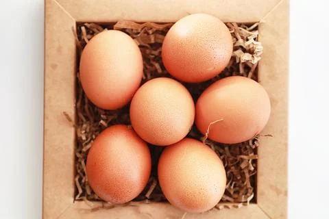 Chicken brown eggs on a white table 스톡 사진