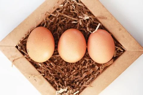 Chicken brown eggs on a white table 스톡 사진