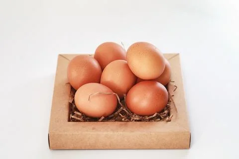 Chicken brown eggs on a white table 스톡 사진