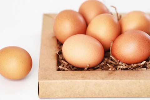 Chicken brown eggs on a white table 库存照片