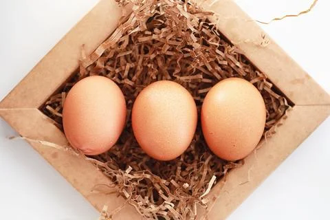 Chicken brown eggs on a white table 스톡 사진