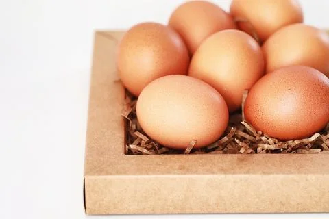Chicken brown eggs on a white table 스톡 사진