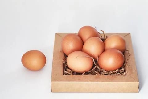 Chicken brown eggs on a white table 스톡 사진