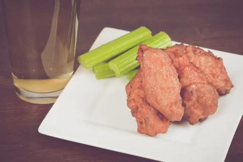 Chicken Buffalo Wings with Celery Sticks and Beer Stock Photos