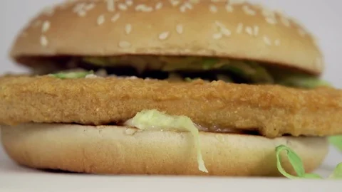 Chicken burger falling in slow motion on white background. Stock Footage 72622368
