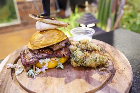 Chicken burger with fried vegetables Stock Photos