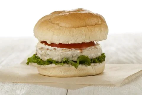 Chicken burger on the paper wrapper Stock Photos