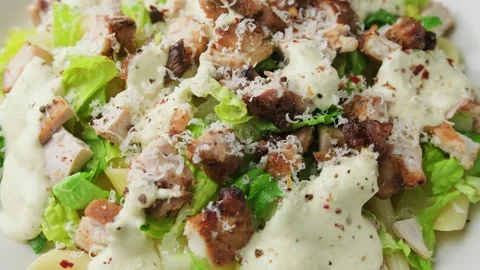 Chicken Caesar Pasta Salad with sauce in white plate. Healthy food. Rotating Vidéo 278421561