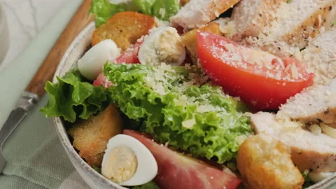 Chicken Caesar salad with chicken breast fillet in a plate with fork Stock Footage 220480622