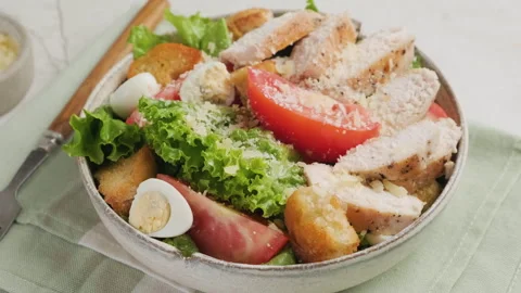 Chicken Caesar salad with chicken breast fillet in a plate with fork. Close up Stock Footage 251017548