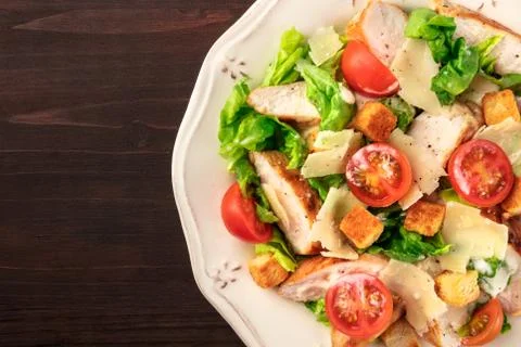 Chicken Caesar salad on dark rustic background with copyspace 写真素材