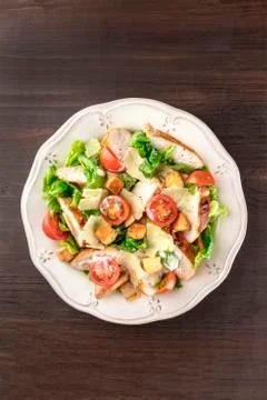 Chicken Caesar salad on dark rustic background with copyspace 写真素材