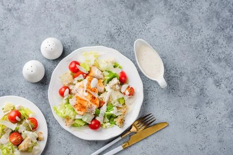 Chicken Caesar Salad With Dressing On White Plate Stock Photos
