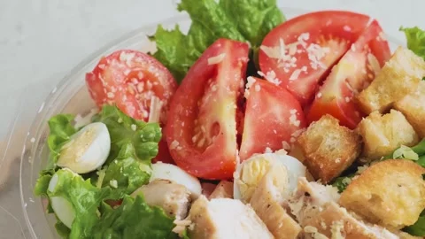 Chicken Caesar salad in plastic package for healthy take away or food delivery Stock Footage 261598855