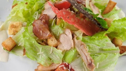 Chicken Caesar salad, served with parmesan cheese, bacon, crouton 스톡 동영상 80982484