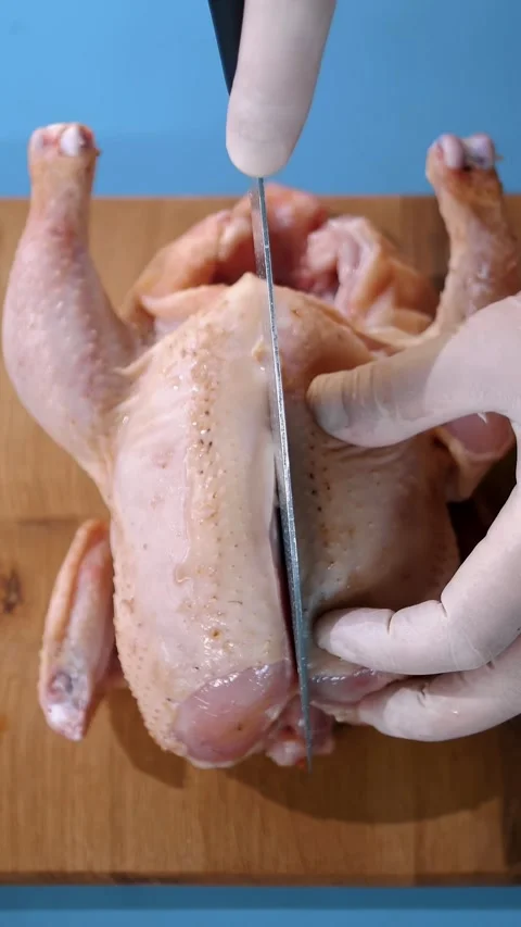 Chicken. Chef preparing food. close-up. top view. Butcher is chopping a fresh Video stock 316260317