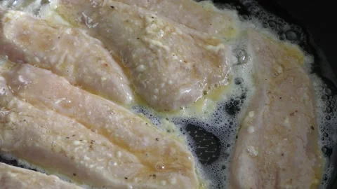 Chicken chops frying in a pan Stock Footage 198978261