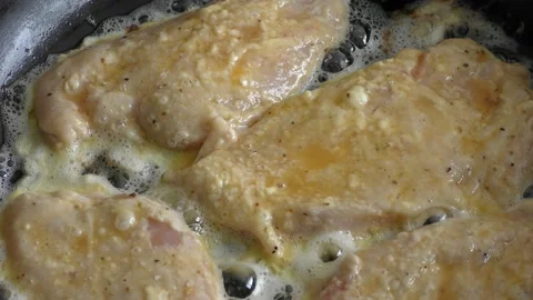 Chicken chops frying in a pan Stock Footage 198978831