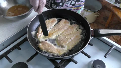 Chicken chops frying in a pan Stock Footage 198979051