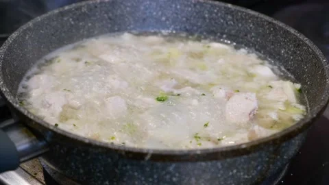 The chicken is cooked in a pan on the stove. Stock Footage 200794108