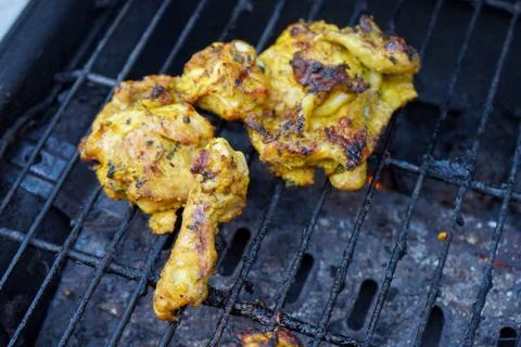 Chicken cooking on a BBQ 写真素材