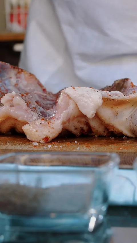 Chicken. cooking. close-up. Chef is sprinkling, rubbing a fresh raw chicken with Stock Footage 317308937
