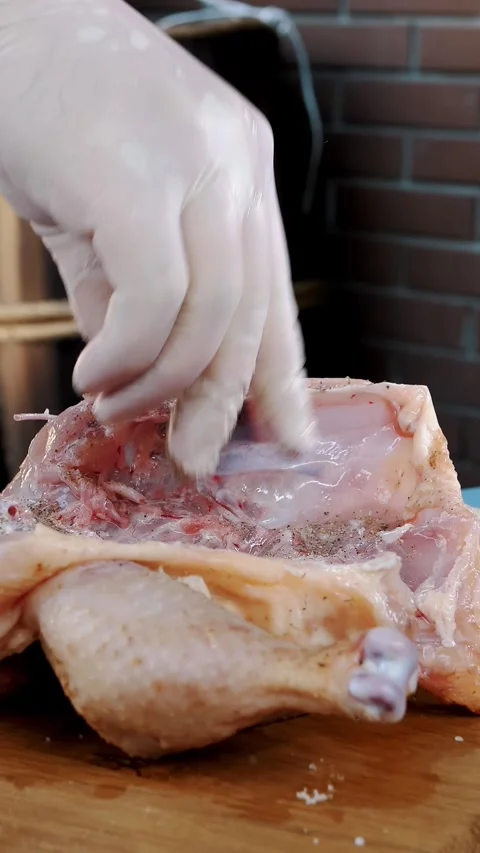 Chicken. cooking. close-up. Chef is sprinkling, rubbing a fresh raw chicken with Stock-Footage 317845197