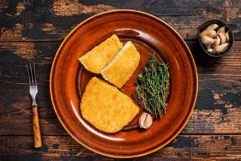 Chicken cordon bleu meat roll cutlet with ham and cheese. Dark wooden background Stock Photos