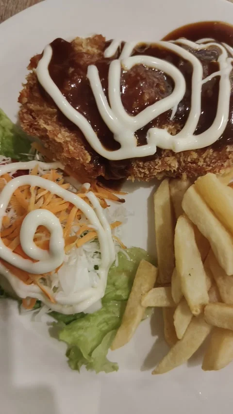 Chicken cordon bleu, vegetable salad and french fries in one plate Stock Footage 288564771