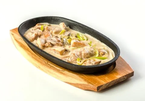Chicken with cream in pan Stock Photos