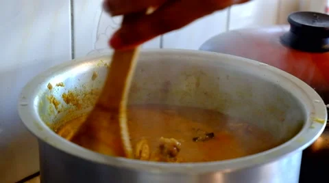 Chicken curry being stirred by chef Stock Footage 44532399