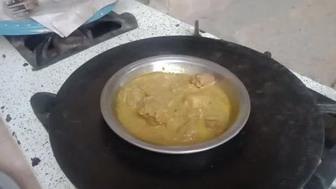 Chicken Curry Heating in a Traditional Pan Over the Stove Stock Footage 346427779