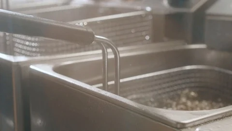 Chicken cutlets are pulled from deep-fried boiling dripping oil Stock Footage 113867533