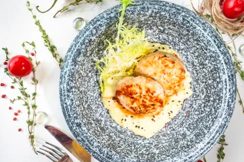 Chicken cutlets with mashed potatoes in a marble plate on a table in a restau Stock Photos
