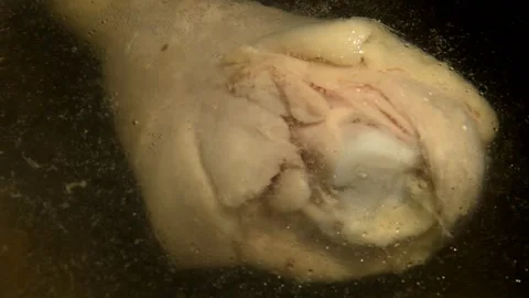 Chicken drumstick is being boiled Stockbeeldmateriaal 302136161