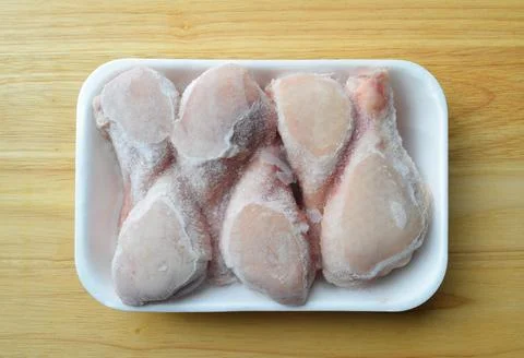 Chicken drumsticks in a container Stock Photos