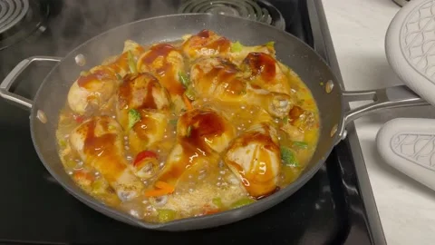 Chicken drumsticks fried in a pan with vegetables and teriyaki sauce Stock Footage 207691664